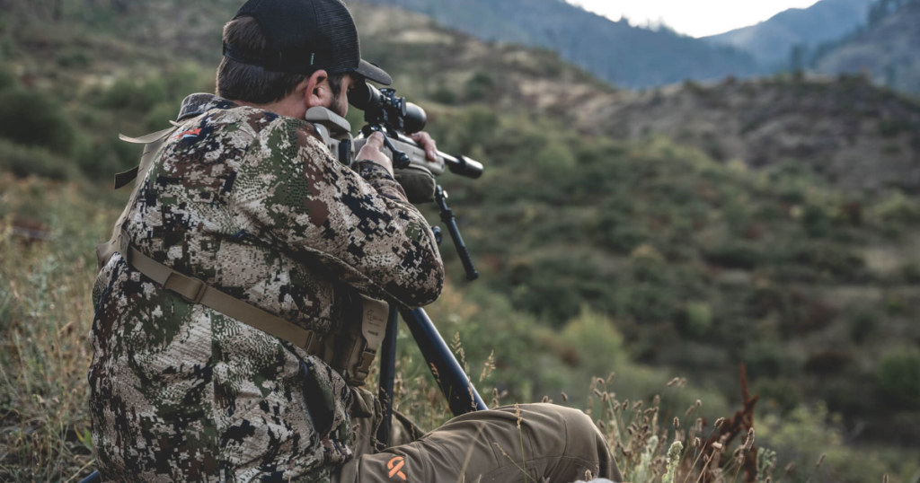 A man using a Cole-TAC shooting support bag to steady his rifle during an PRS competition.