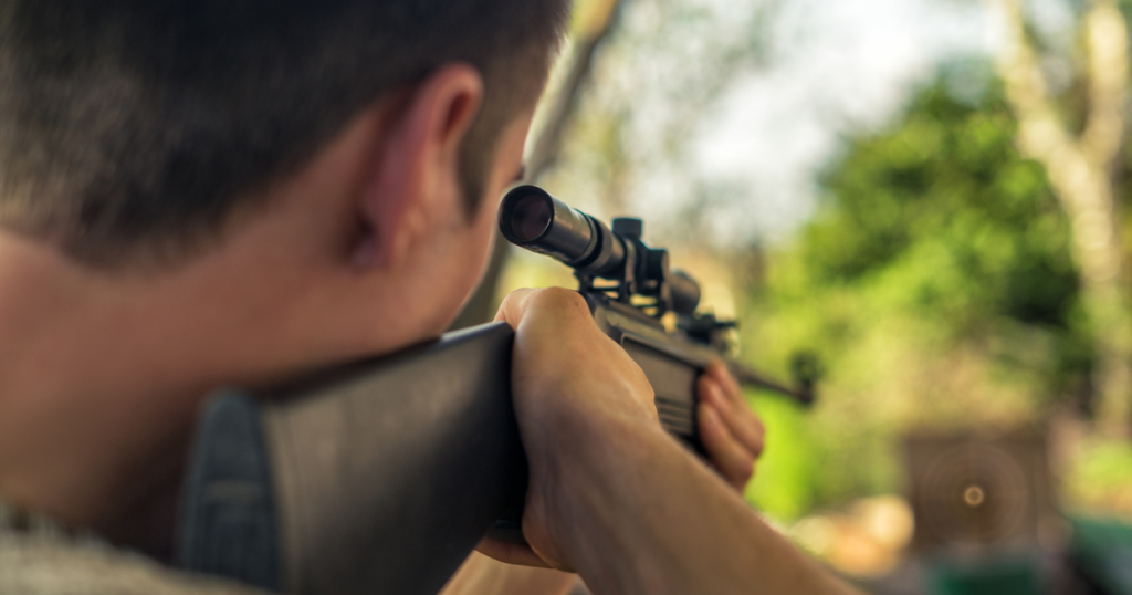 A man at the shooting range during the summer running rifle drills.
