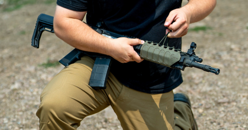 A man putting the SD Hanguard by Cole-TAC on his rifle.