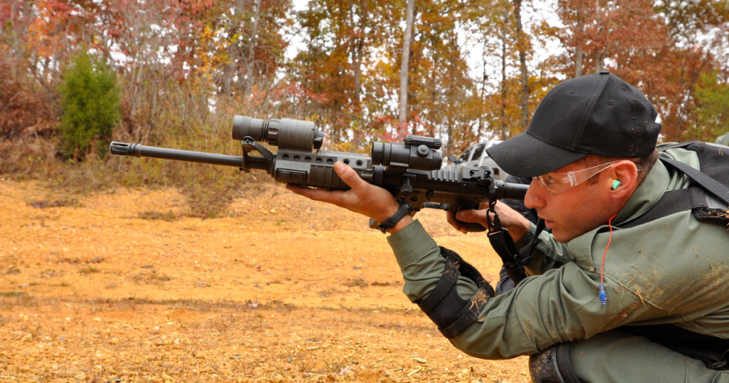A man shifting to a crouching positions during an NRL shooting competition.