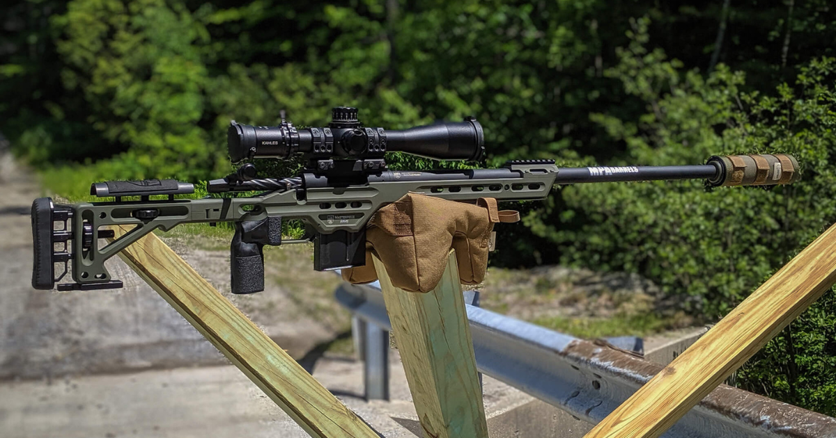 A rifle at the shooting range during the summer being supported by a Cole-TAC shooting support bag.