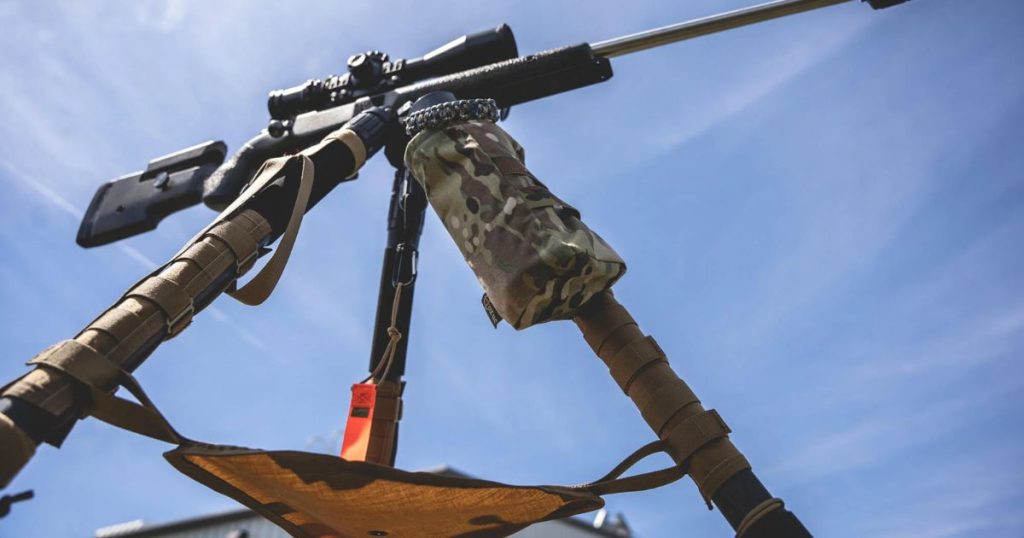 A Cole-TAC waterbottle holder attached to a tripod.