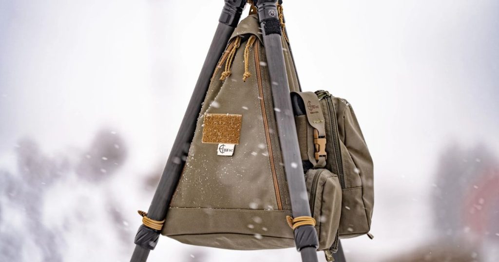 A Cole-TAC Bird Box attached to a tripod in the snow.