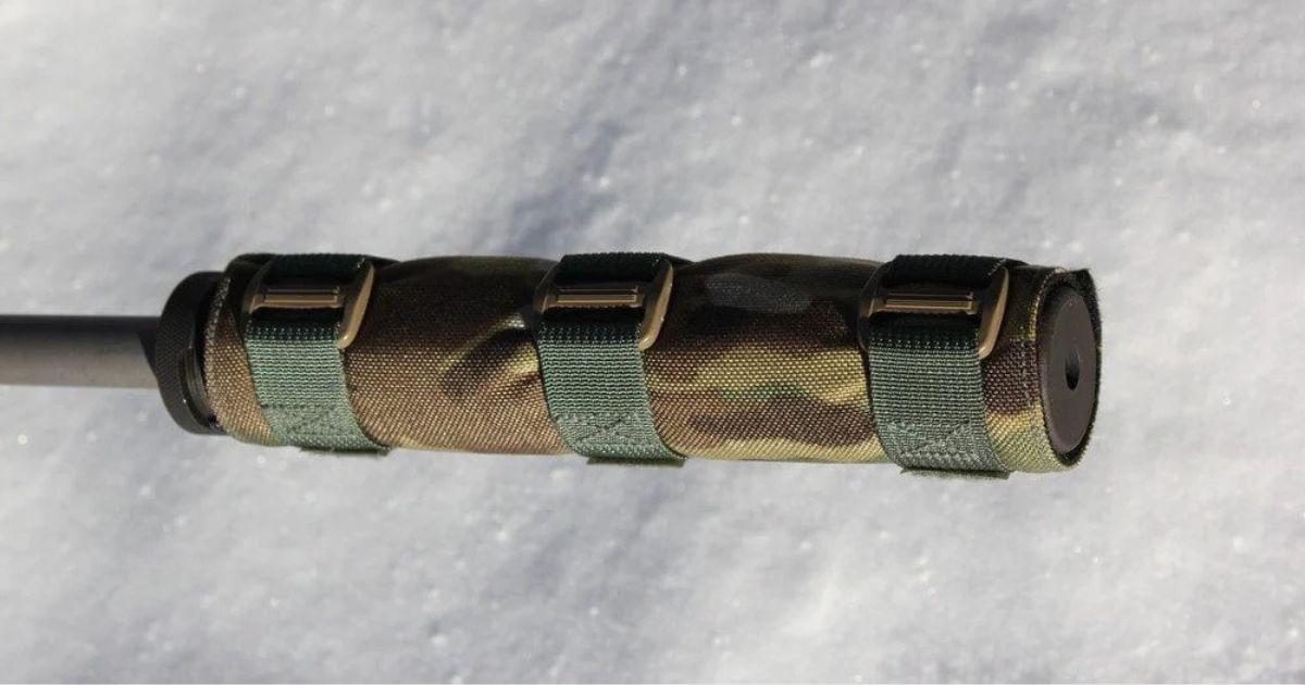 A Cole-TAC Suppressor Cover in a camo pattern against a snowy background.
