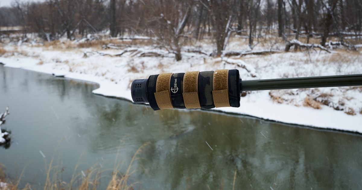 A Cole-TAC Suppressor Cover on a rifle out in the snow.