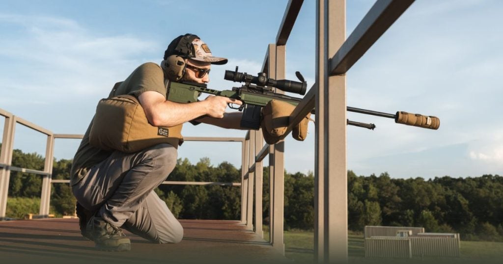 A man using a Cole-TAC suppressor cover and shooting bag with his long range rifle.