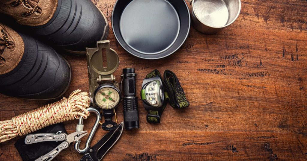 Different hunting gear on a wooden table.