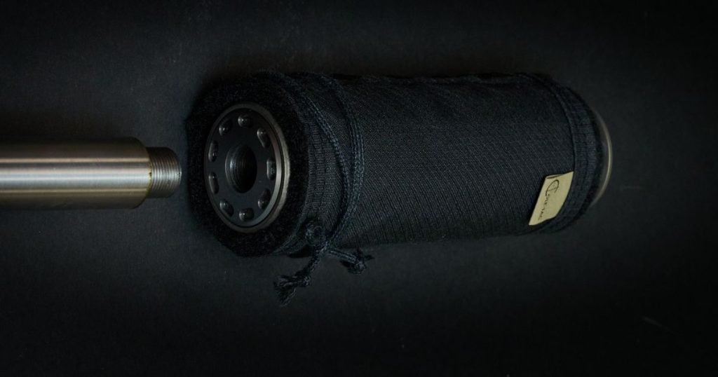 A suppressor with a black Cole-TAC Corset Suppressor Cover on it.
