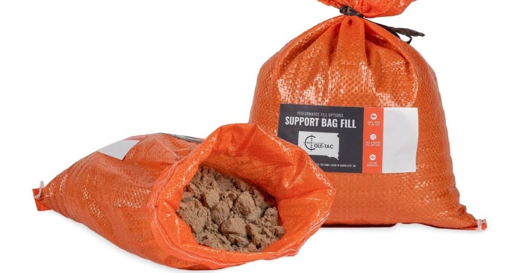 Two orange bags filled with Cole-TAC's CompFill for shooting bags.