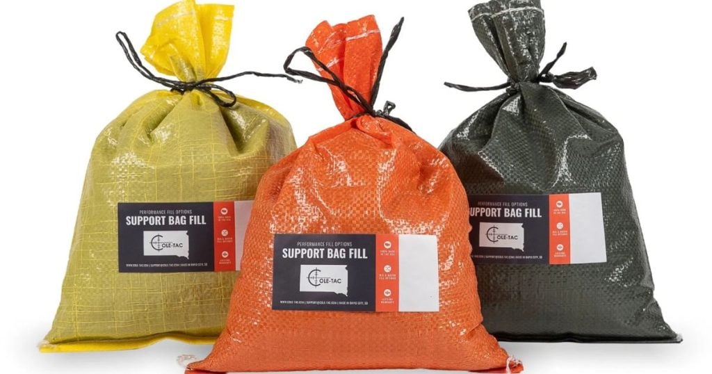 Three bags of different Cole-TAC shooting fill on a white background.