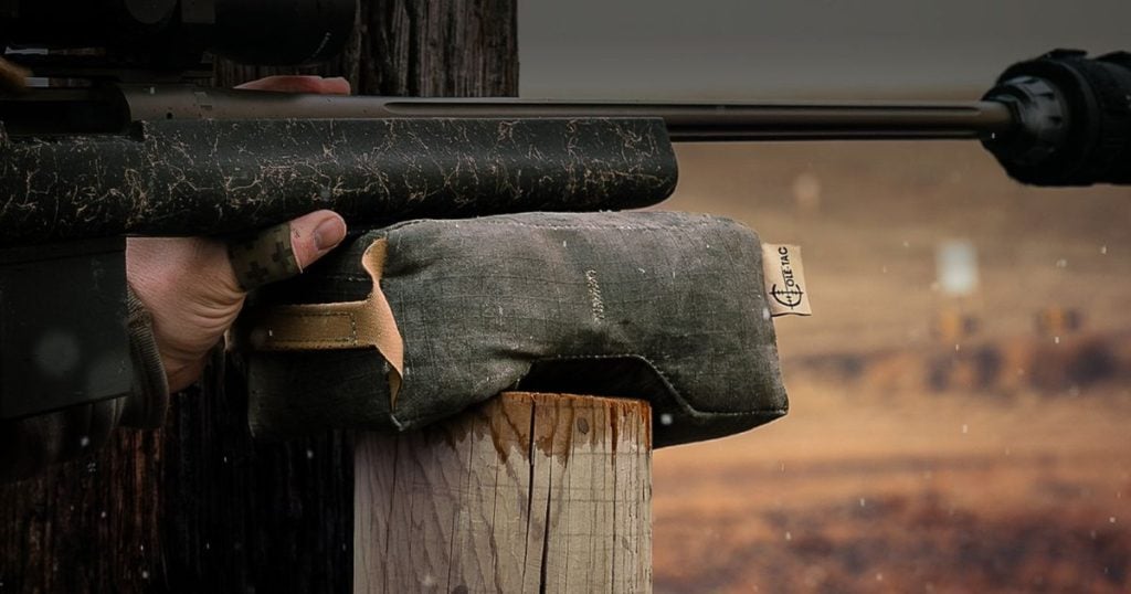 Cole-TAC's Revolution Bag sitting on a post with a rifle on top ready to shoot.