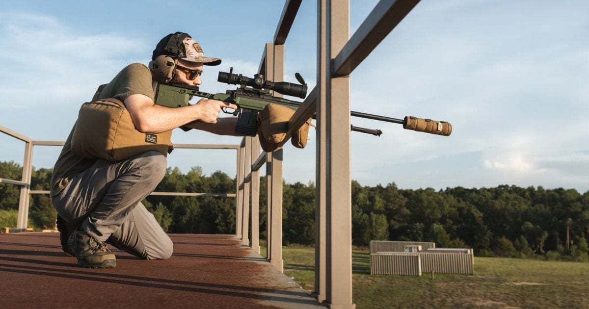 A man using a Cole-TAC support to stablize his rifle for long range shooting.